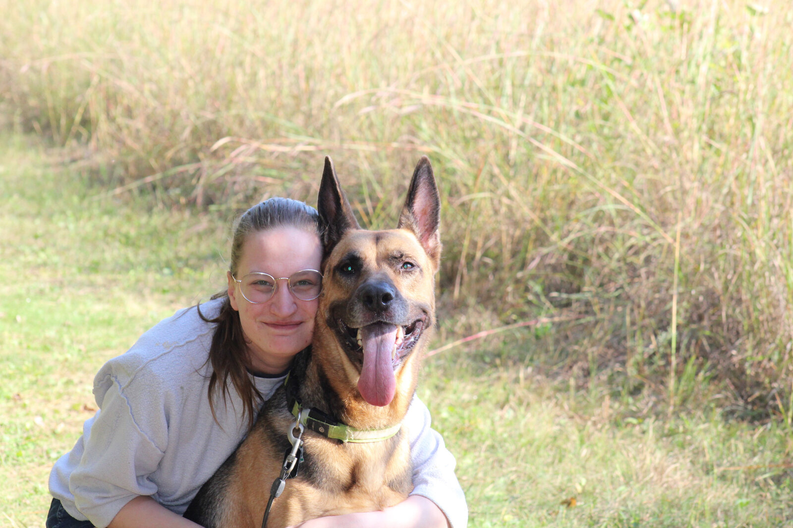 Tyler's wife, Kyrsten, with their dog, Woden, outdoors